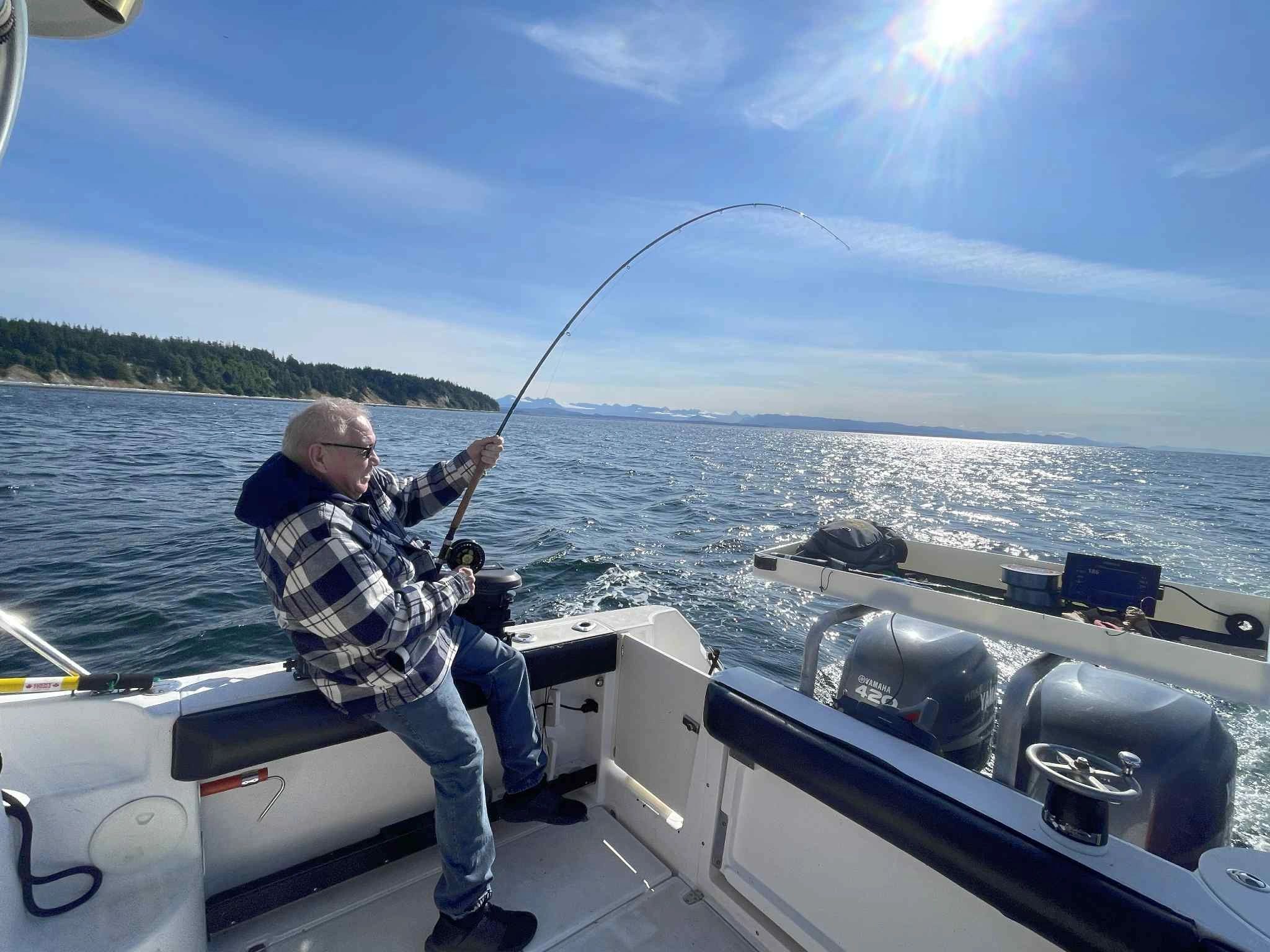Angler fighting salmon action shot