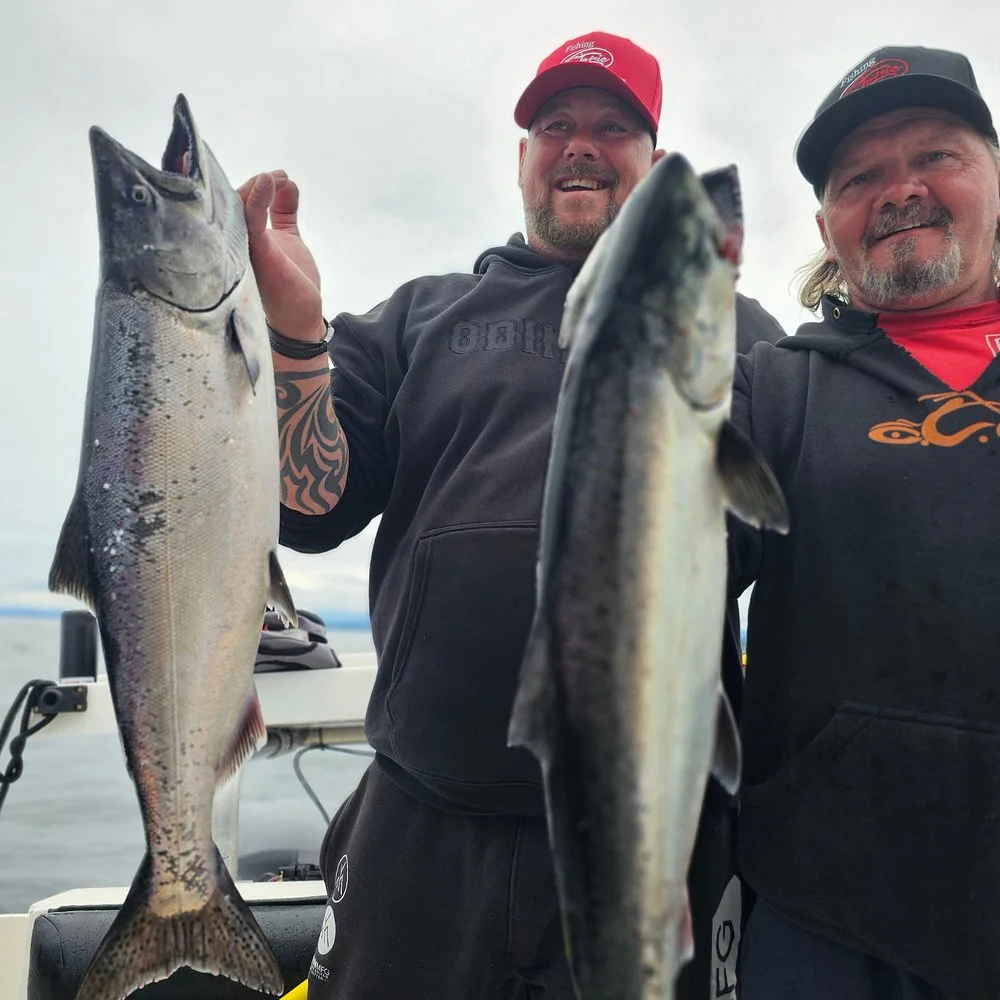 Captain Norm Sewid with guests displaying salmon catches Campbell River