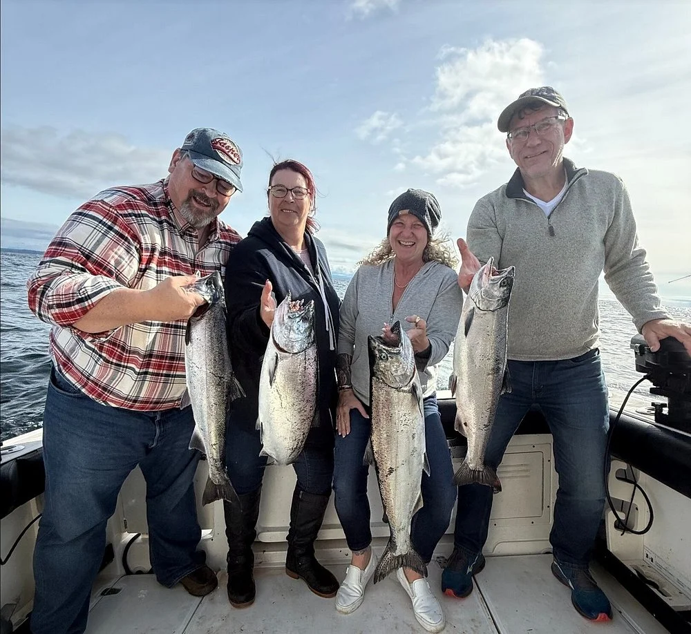 Group of four anglers with salmon catches on Campbell River fishing charter