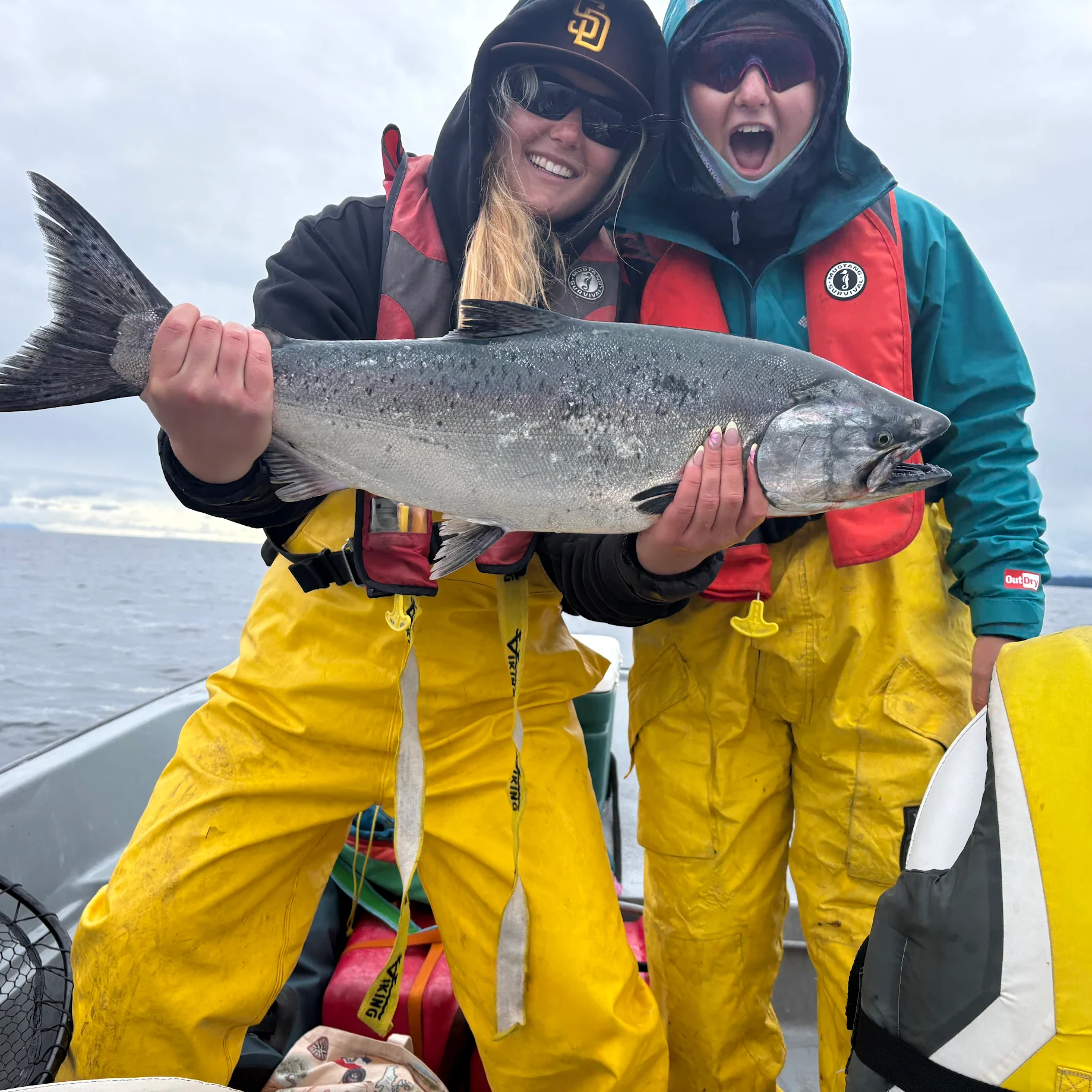 Two women anglers celebrating a trophy Chinook salmon catch on a Campbell River BC guided fishing charter